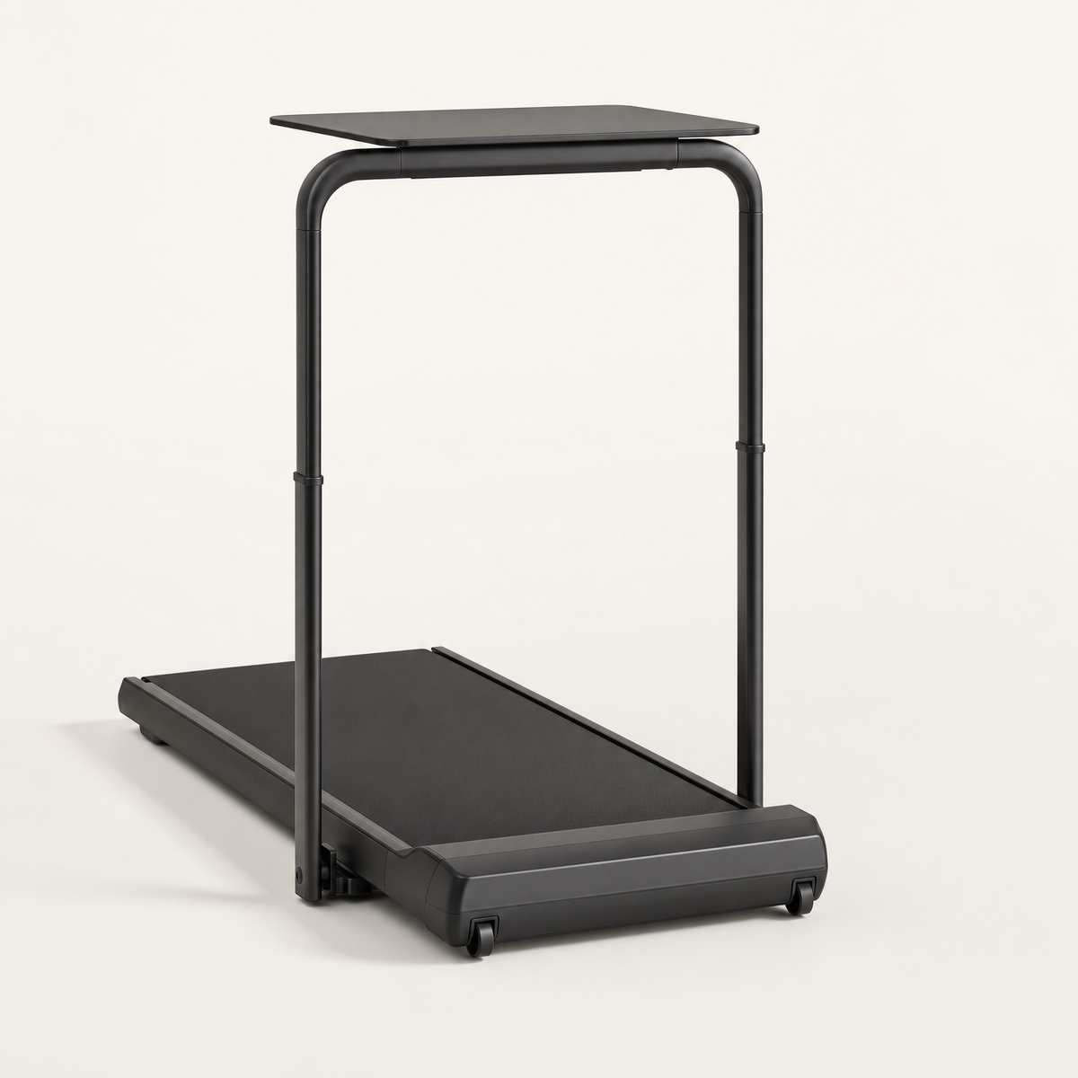 Black walking pad with folding handrail and desk tray, three-quarter view on an off-white background